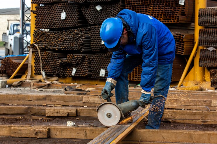 worker cuts iron with tool
